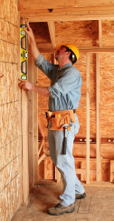 Carpenter doing framing with Box level